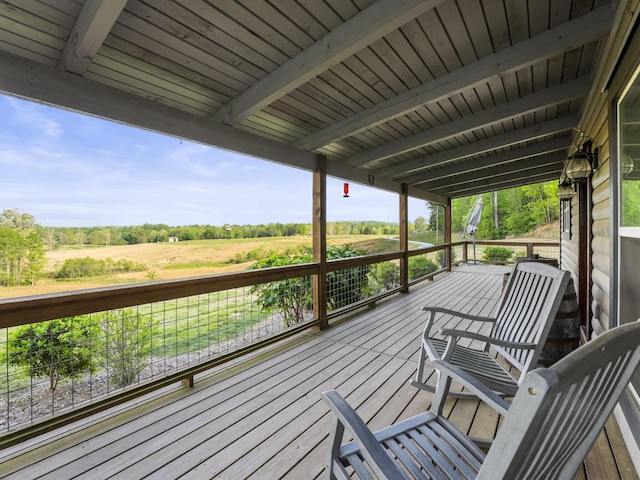 wooden deck with a rural view