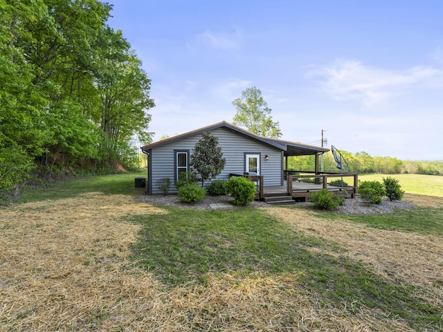 exterior space with a wooden deck and a lawn
