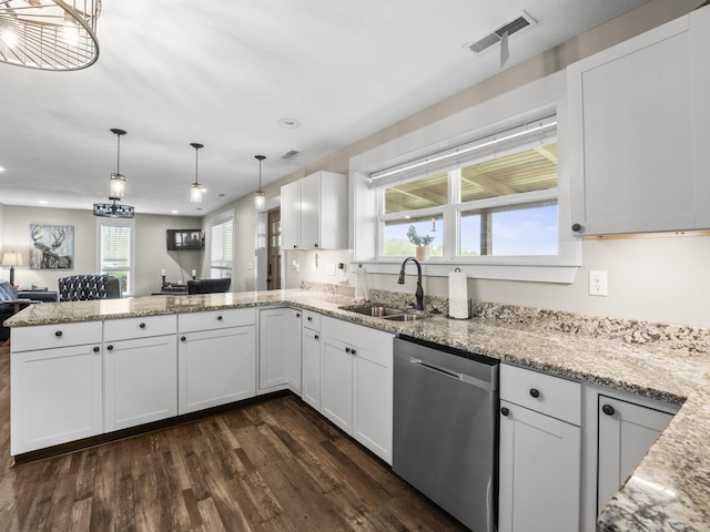 kitchen featuring a peninsula, a sink, stainless steel dishwasher, visible vents, and dark wood-style floors