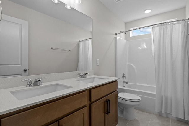 bathroom featuring toilet, shower / tub combo, tile patterned flooring, and a sink