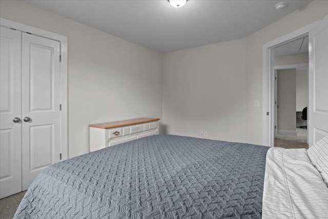 bedroom featuring carpet flooring and attic access