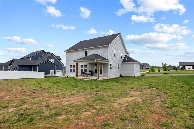 back of house with a yard, a patio, fence, and a ceiling fan