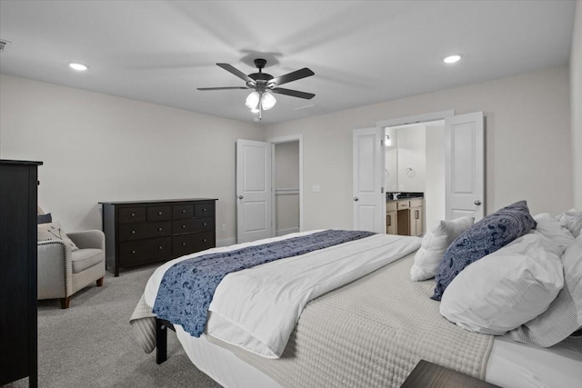 carpeted bedroom with a ceiling fan, ensuite bathroom, and recessed lighting