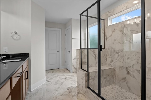 full bathroom with marble finish floor, a marble finish shower, baseboards, and vanity