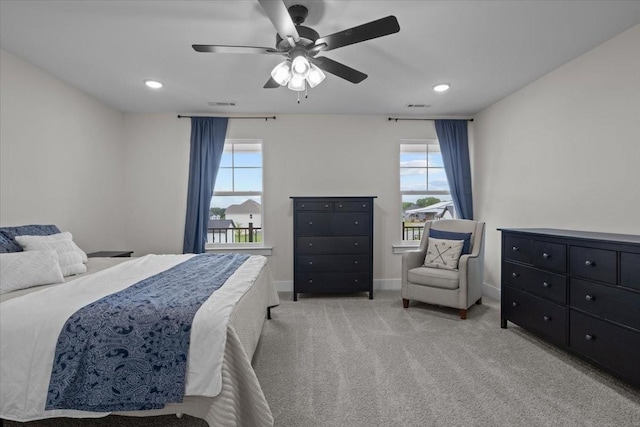 bedroom featuring multiple windows, light carpet, and visible vents