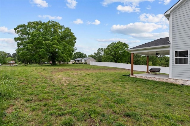 view of yard featuring a patio area, fence, and a ceiling fan