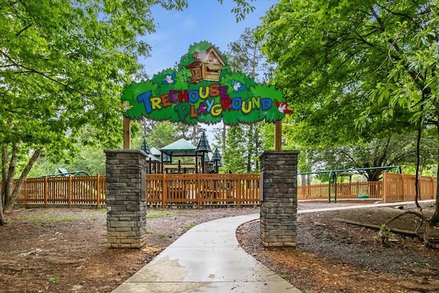 view of property's community featuring playground community and fence