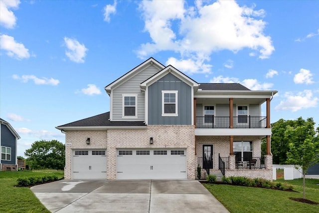 craftsman house with concrete driveway, a front lawn, brick siding, and board and batten siding