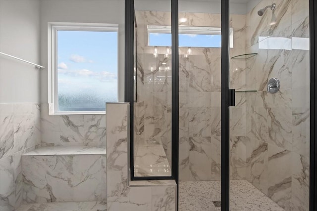 full bathroom with a marble finish shower