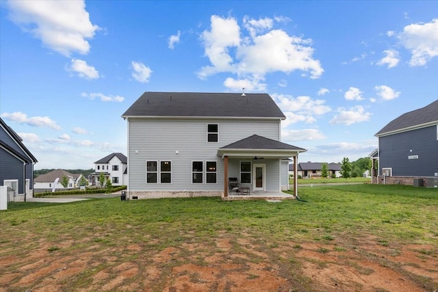 rear view of house with a patio, a lawn, ceiling fan, and central AC