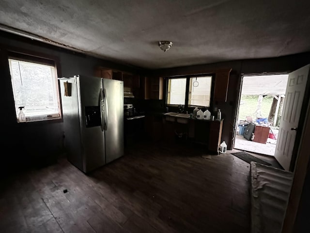 kitchen featuring a sink, dark wood-style flooring, stainless steel fridge with ice dispenser, and plenty of natural light