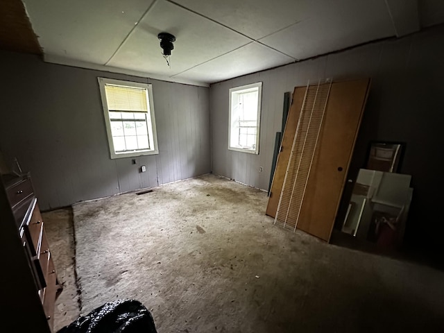 unfurnished bedroom featuring visible vents and multiple windows