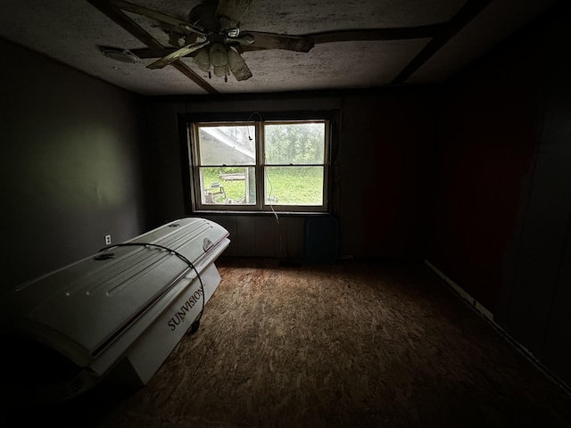 bedroom with a textured ceiling and ceiling fan