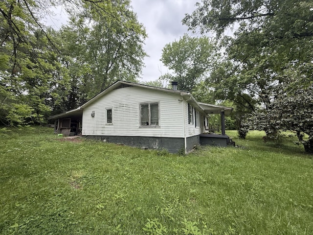 view of side of property with a lawn