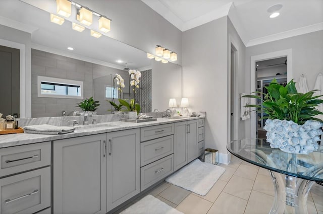 full bathroom featuring tile patterned floors, crown molding, a sink, and double vanity