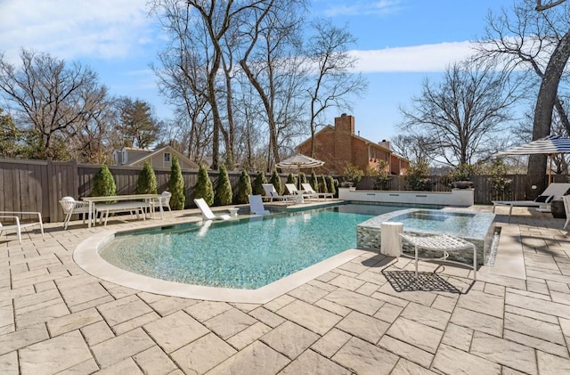 view of pool with a patio, an outdoor hot tub, a fenced in pool, and a fenced backyard