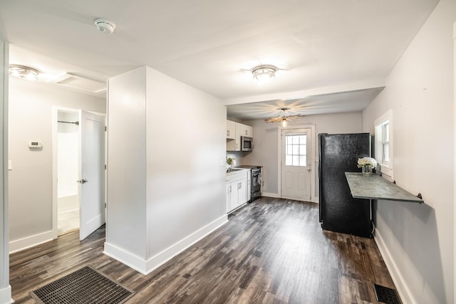 709 Ann Ave, Gallatin, TN 37066 - kitchen with white cabinetry, baseboards, black appliances, and dark wood-type flooring
