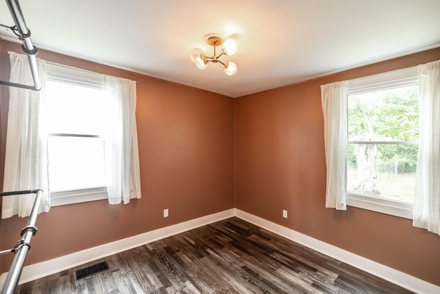709 Ann Ave, Gallatin, TN 37066 - empty room with an inviting chandelier, dark wood-style flooring, baseboards, and visible vents
