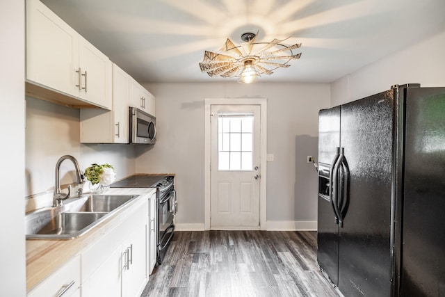 709 Ann Ave, Gallatin, TN 37066 - kitchen featuring a sink, white cabinetry, dark wood-style flooring, baseboards, and black appliances