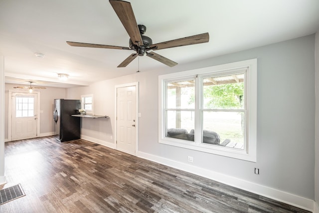 709 Ann Ave, Gallatin, TN 37066 - unfurnished living room featuring ceiling fan, baseboards, dark wood-type flooring, and visible vents