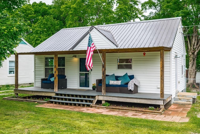 709 Ann Ave, Gallatin, TN 37066 - back of property featuring a yard, outdoor lounge area, and metal roof