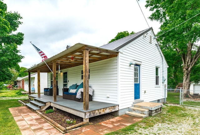 709 Ann Ave, Gallatin, TN 37066 - back of property with a lawn, fence, metal roof, a wooden deck, and a gate