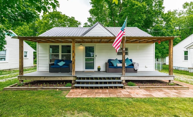 709 Ann Ave, Gallatin, TN 37066 - rear view of house featuring a yard, metal roof, and an outdoor living space