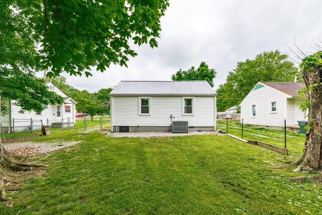 709 Ann Ave, Gallatin, TN 37066 - rear view of house with a lawn, central air condition unit, metal roof, and fence