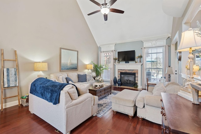 living area featuring a stone fireplace, dark wood finished floors, ceiling fan, and high vaulted ceiling