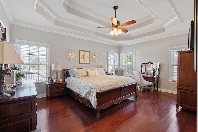 bedroom featuring baseboards, dark wood-style flooring, ceiling fan, crown molding, and a raised ceiling