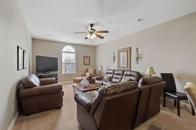 carpeted living area featuring baseboards, visible vents, and ceiling fan