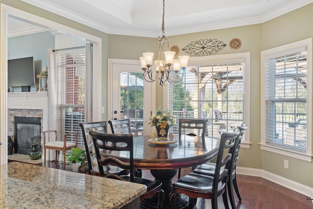 dining room with a wealth of natural light, an inviting chandelier, and dark wood-type flooring