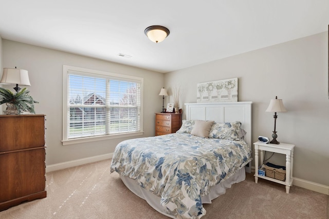 carpeted bedroom with baseboards and visible vents