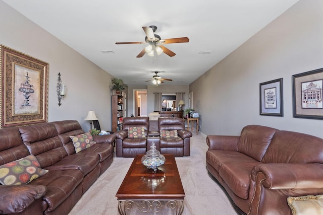 living room featuring ceiling fan, light carpet, and visible vents