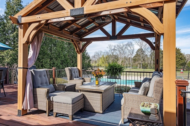 view of patio / terrace with fence, a deck, a gazebo, an outdoor hangout area, and a fenced in pool