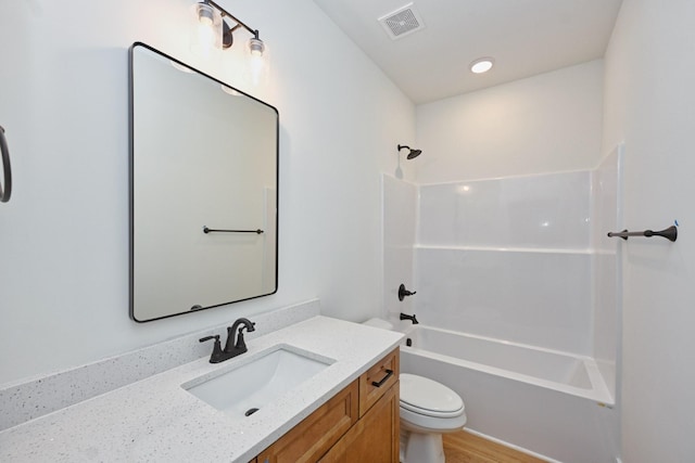 bathroom with toilet, wood finished floors, shower / washtub combination, visible vents, and vanity