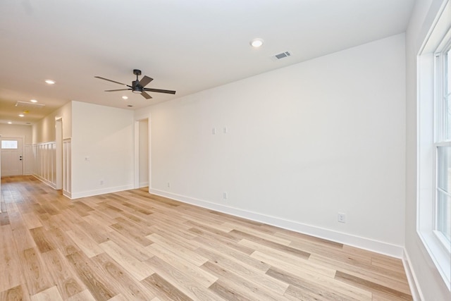 empty room with visible vents, recessed lighting, light wood-style flooring, a ceiling fan, and baseboards