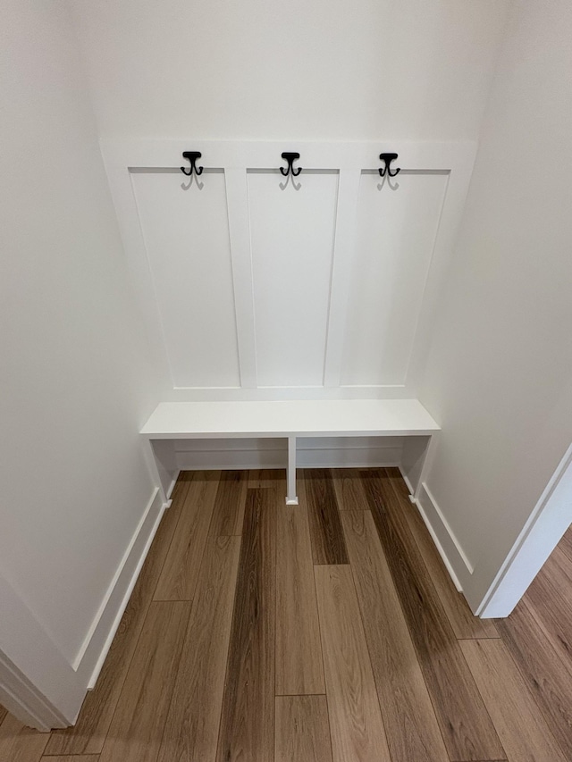 mudroom featuring wood finished floors and baseboards