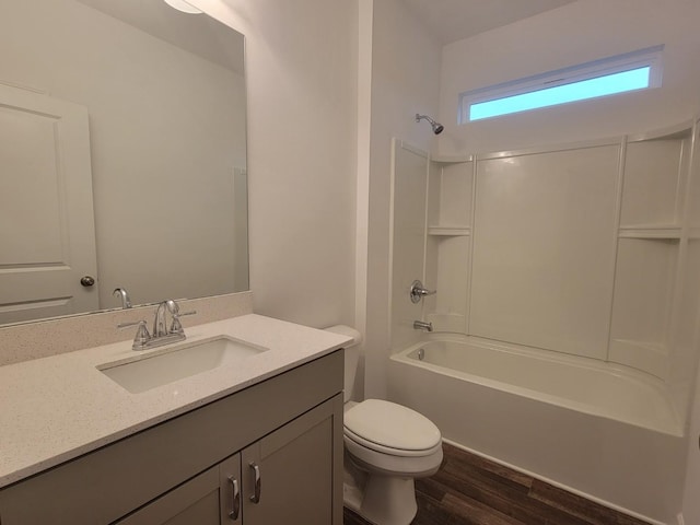 full bathroom featuring vanity, toilet, tub / shower combination, and wood finished floors