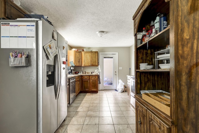 608 Dean Rd, Clarksville, TN 37040 - kitchen with stainless steel appliances, a textured ceiling, open shelves, brown cabinets, and light countertops
