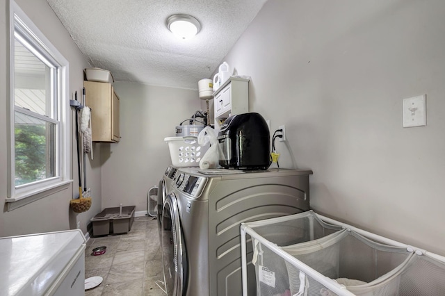 608 Dean Rd, Clarksville, TN 37040 - clothes washing area with separate washer and dryer, a textured ceiling, cabinet space, and baseboards