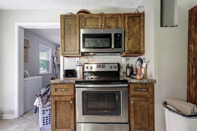608 Dean Rd, Clarksville, TN 37040 - kitchen featuring brown cabinets, appliances with stainless steel finishes, and a textured ceiling