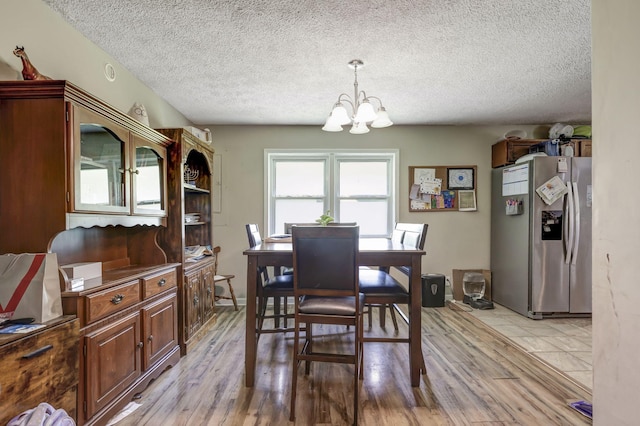 608 Dean Rd, Clarksville, TN 37040 - dining space featuring light wood-style floors, a chandelier, and a textured ceiling