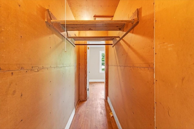 hall featuring wood finished floors and baseboards