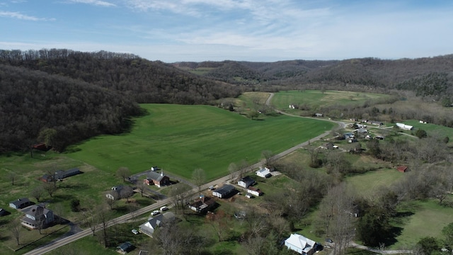 drone / aerial view featuring a rural view and a forest view