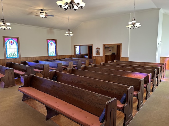 miscellaneous room featuring lofted ceiling, plenty of natural light, and a wainscoted wall