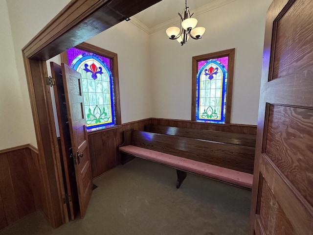 interior space with wooden walls, carpet flooring, and a wainscoted wall
