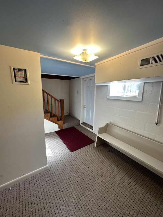 basement featuring stairway, carpet flooring, and visible vents