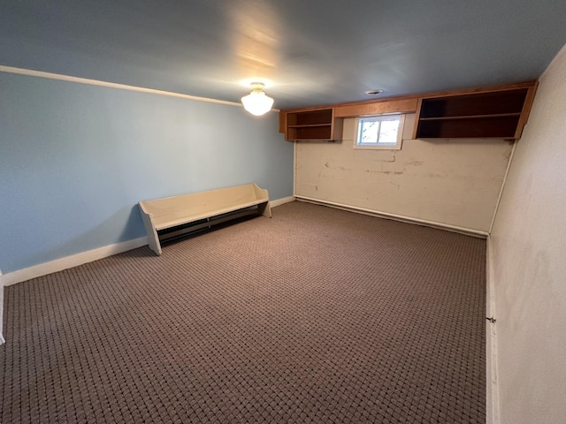 below grade area featuring baseboards and carpet floors