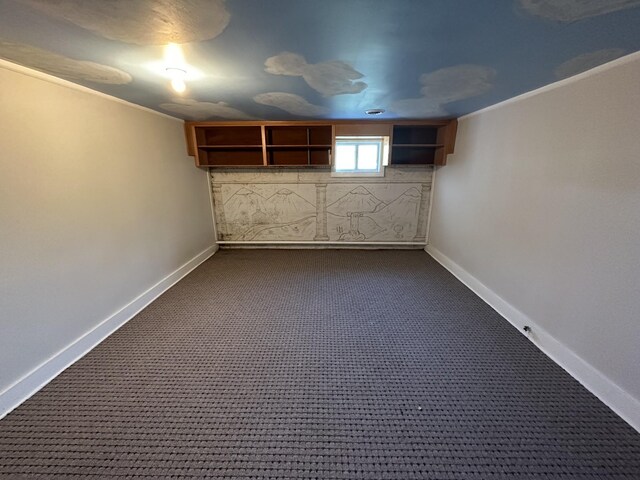 basement with baseboards and dark carpet